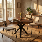 Dining room with wooden table and chairs near large windows.