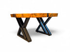 Table with a wooden top and metal X-shaped legs on a white background