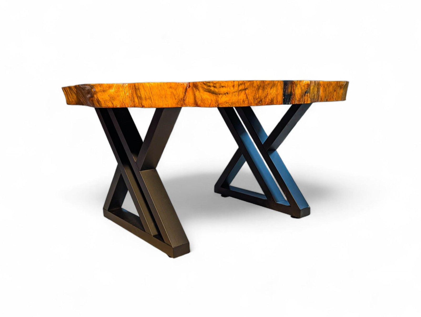 Table with a wooden top and metal X-shaped legs on a white background