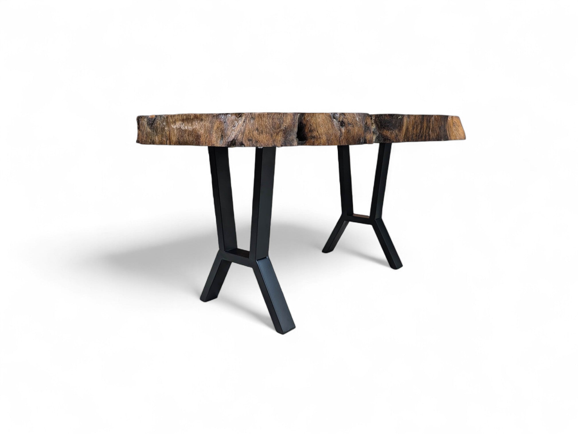 Coffee table with a rustic wooden top and black metal legs on a white background