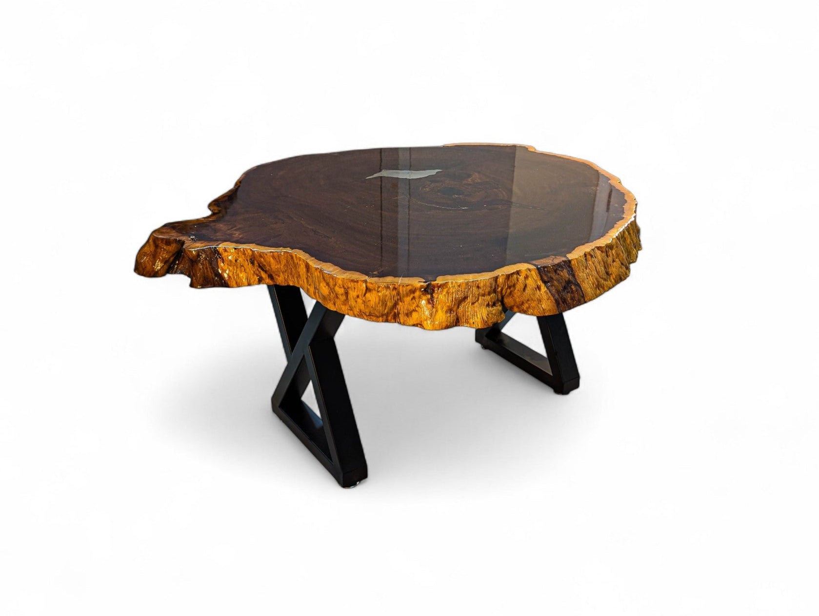 Wooden coffee table with a natural edge design on a white background