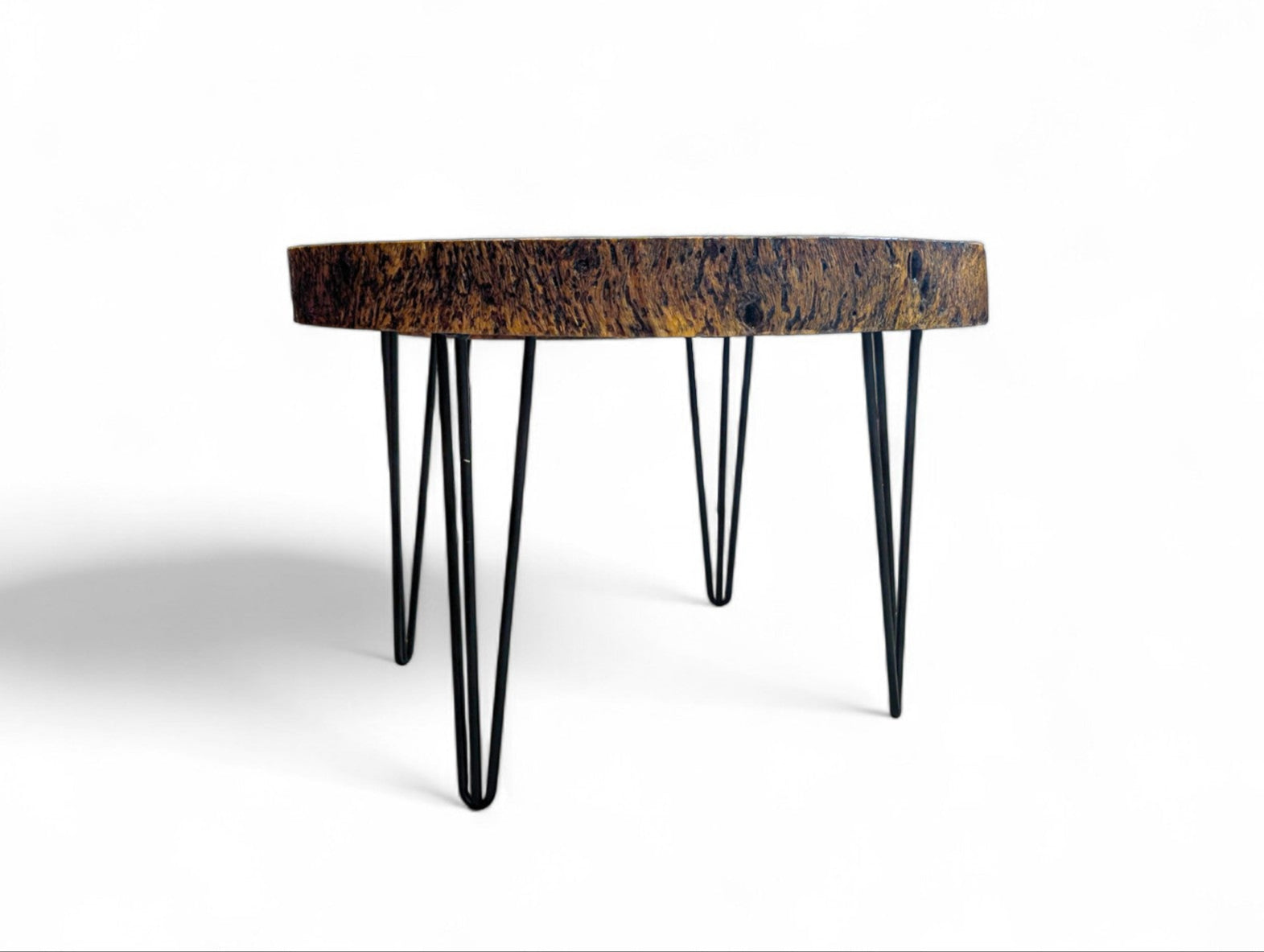 Round wooden table with hairpin legs on a white background