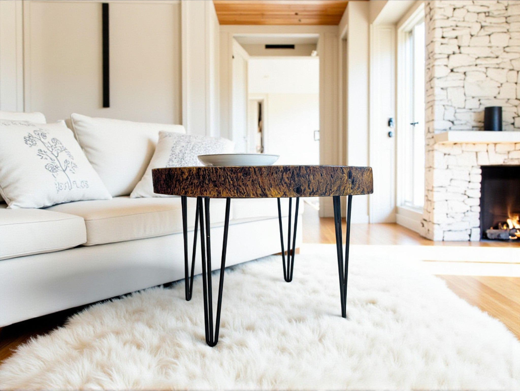 Modern living room with a wooden coffee table, white sofa, and fireplace.